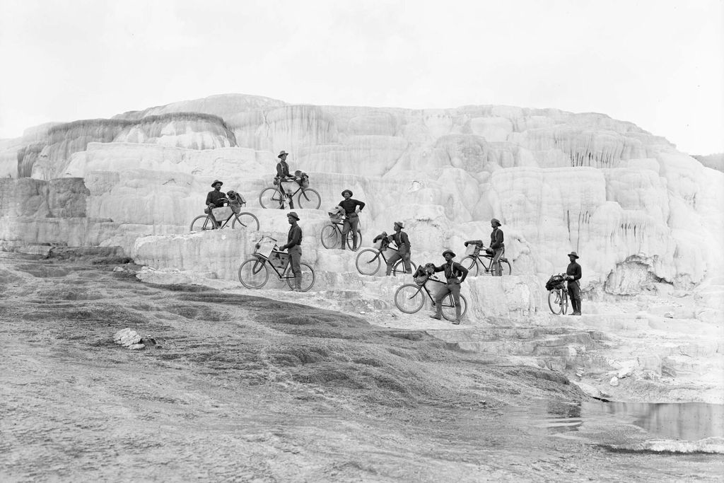 Members of the 25th Infantry Bicycle Corps pose on Minerva Terrace at Mammoth Hot Springs in Yellowstone National Park in 1896