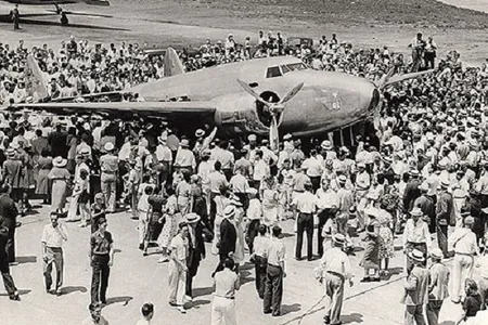 Crowds surround Howard Hughes' Lockheed Model 14-N2 Super Electra, after the aviator's 1938 round-the-world flight.