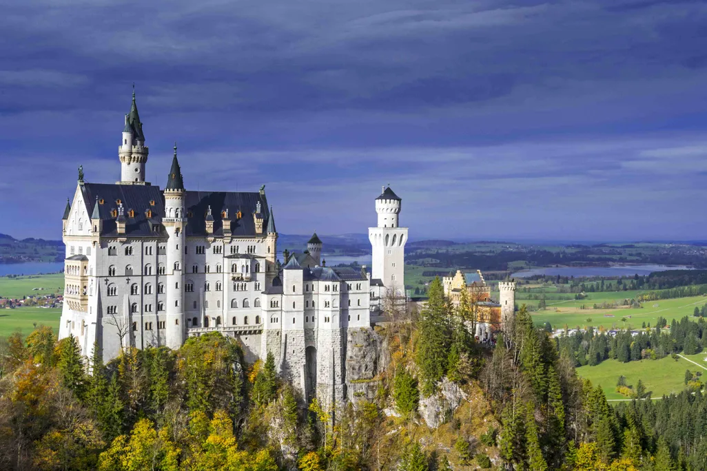 Castle on a hill with trees and blue sky