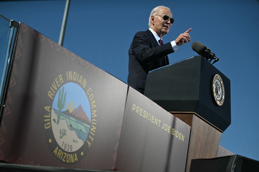 Man wearing aviators making a gesture while giving a speech
