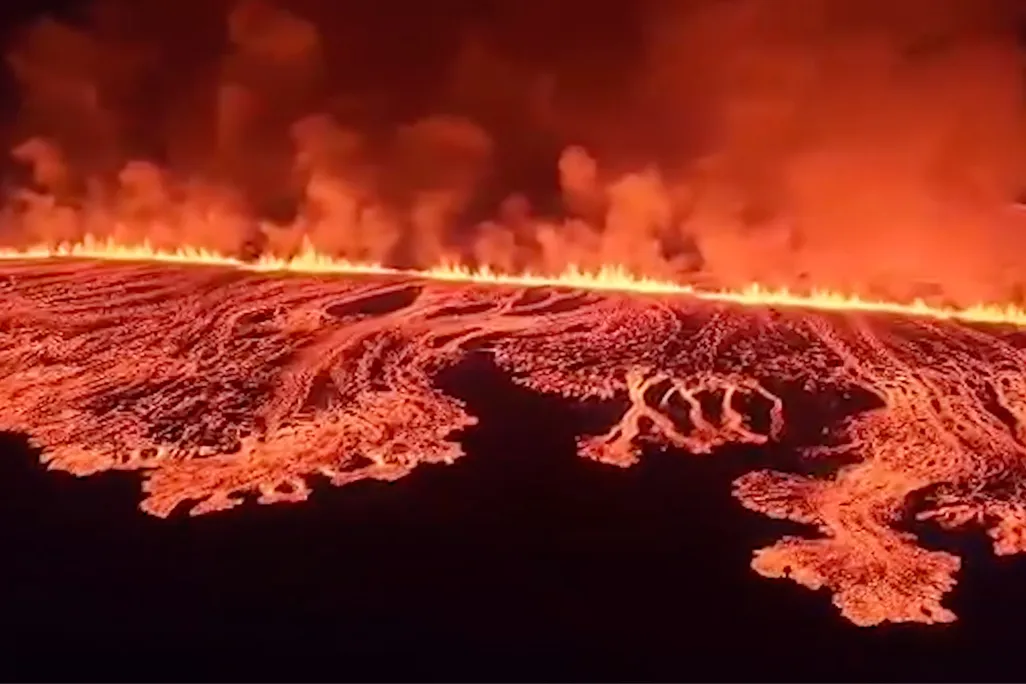 lava erupting and flowing from a long fissure