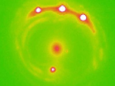 Researchers estimate more than a trillion planets could exist in the elliptical galaxy at the center of this image.