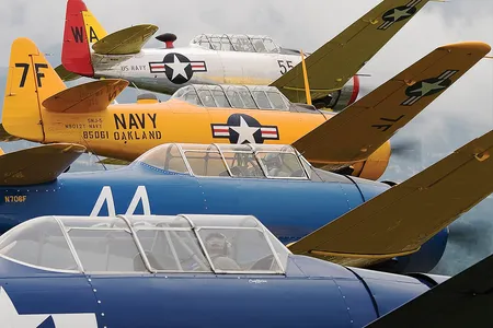 Tighten up (from the top): Heritage Flight Museum founder and Apollo 8 veteran William Anders, Merrill Wien and Alan Anders (in the same aircraft), Craig Nelson, and Greg Anders fly formation to stay sharp for larger warbirds—and just to enjoy the T-6.