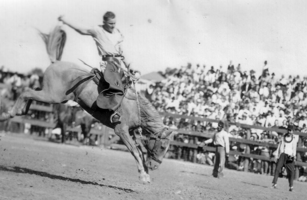 A convict hangs on to a bucking bronco c. 1940