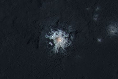The bright spots of Occator Crater are shown in enhanced color in this view from NASA's Dawn spacecraft.