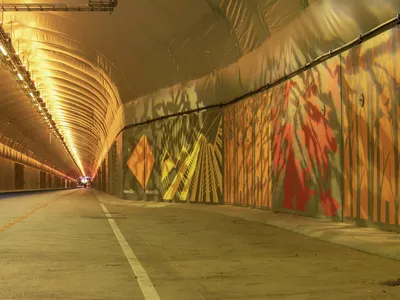Colorful murals help brighten up the windowless tunnel.