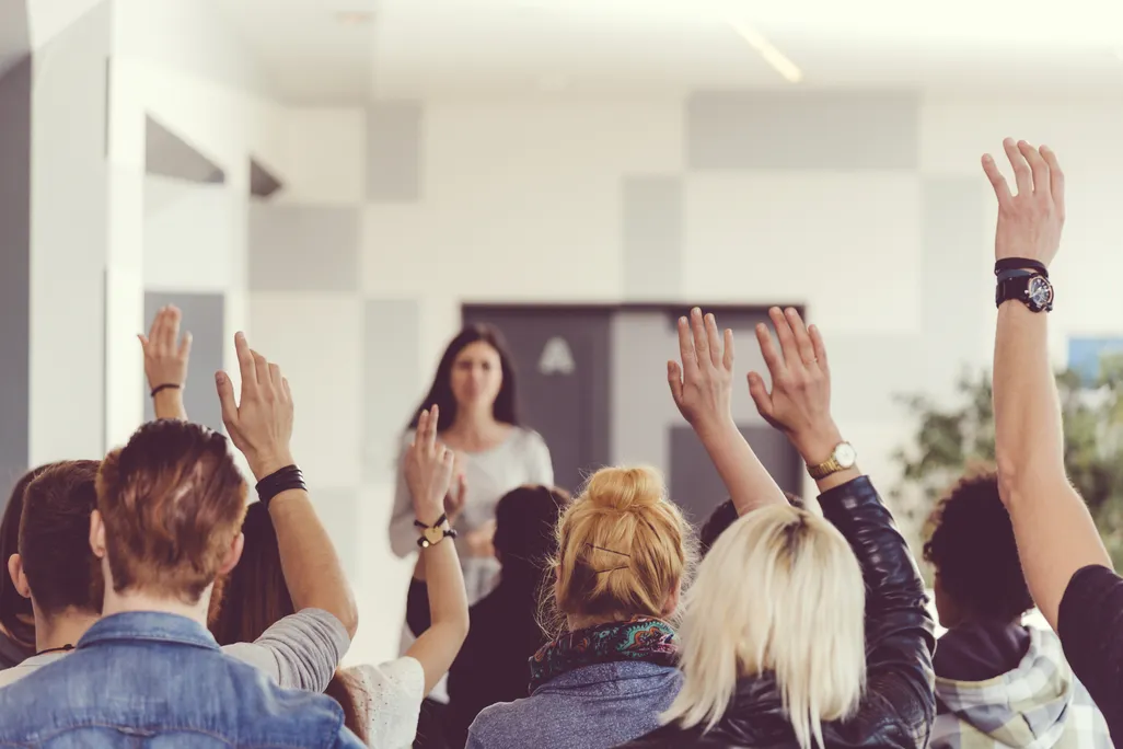 students raising hands