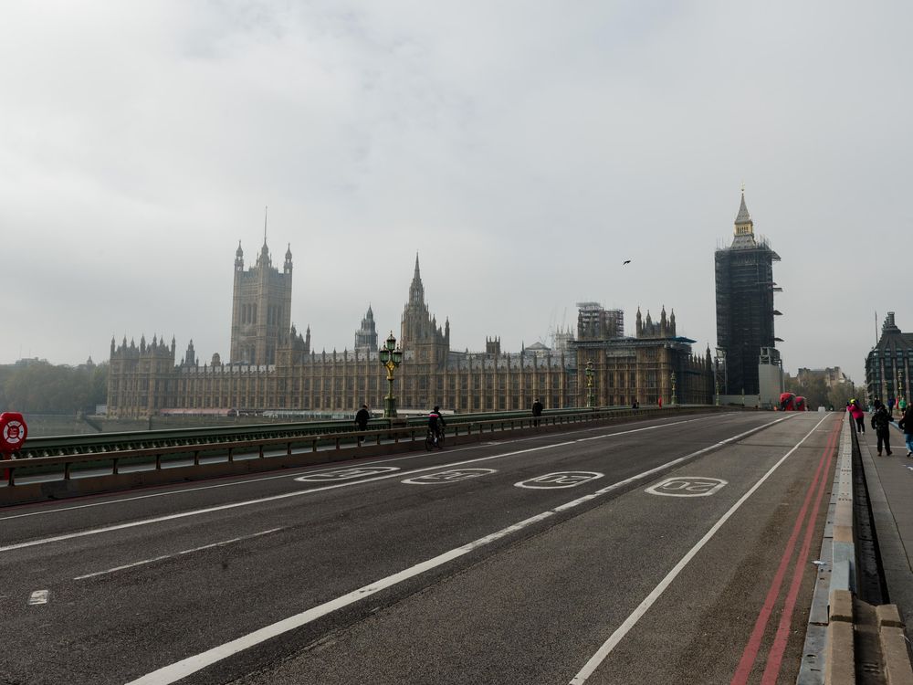 Pedestrians cross an almost deserted Westminster Bridge as England enters a four-week lockdown to tackle the spread of coronavirus, on 05 November, 2020 in London, England