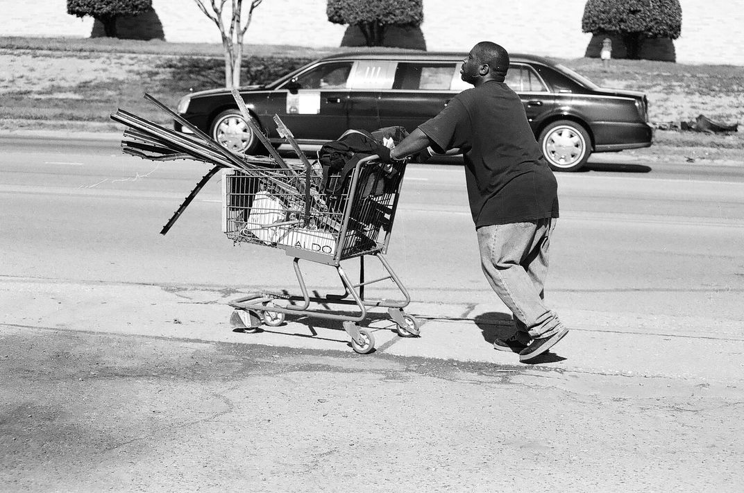 Man taking scrap metal to the recycling facility with a limousine in ...
