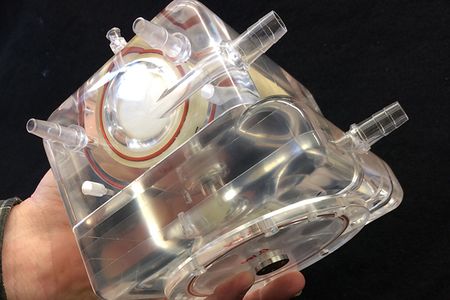 The mechanical lung would function outside the patient's body.