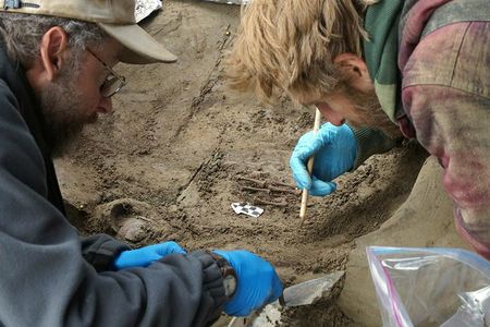 Archaeologists Ben Potter and Josh Reuther, both of the University of Alaska in Fairbanks, excavate the burial pit at the Upward Sun River site. 