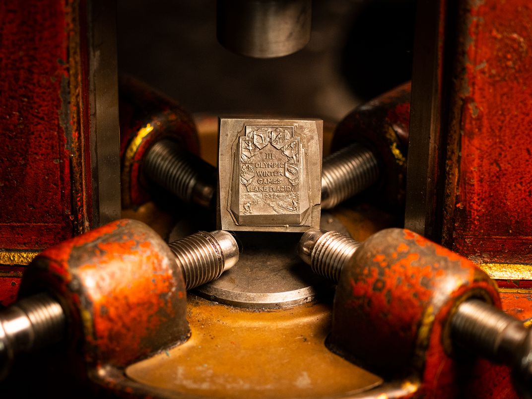 A hand-carved hub for the medals presented to all athletes competing in the 1932 Winter Olympics