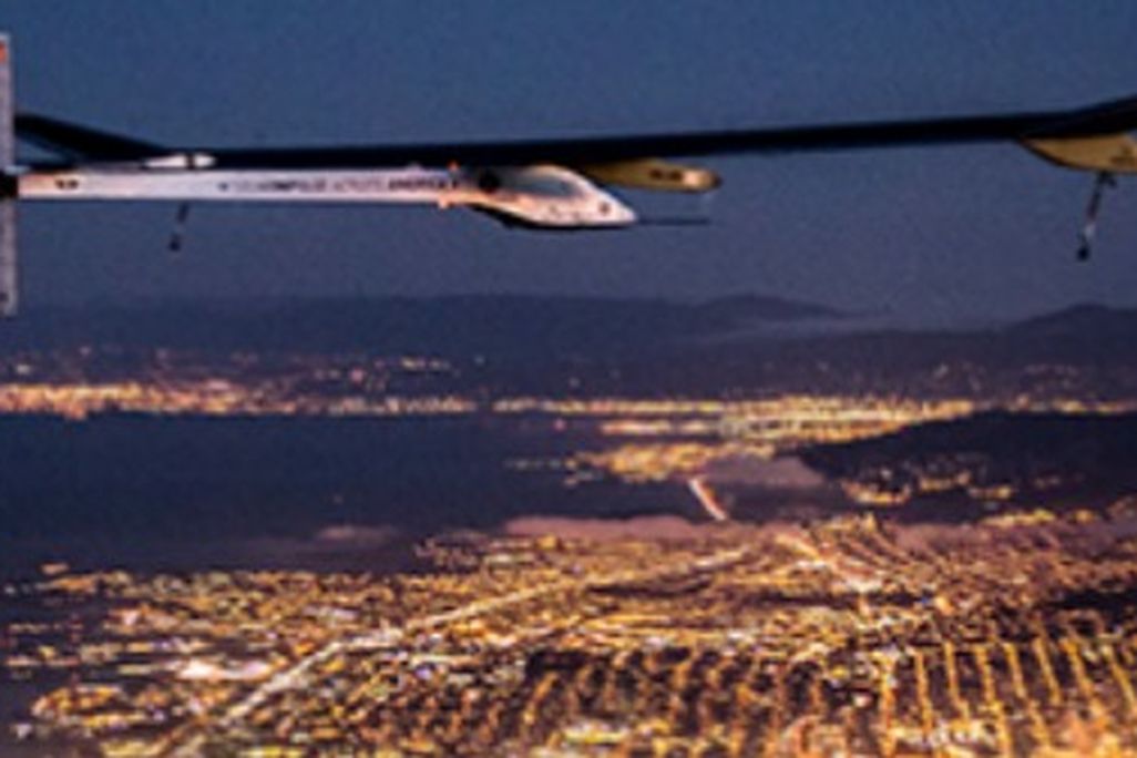 The Solar Impulse flying over San Francisco at night.