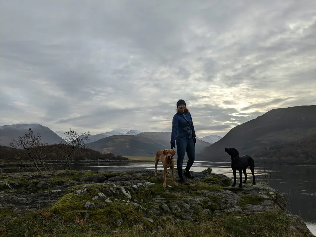 person standing outside with two dogs