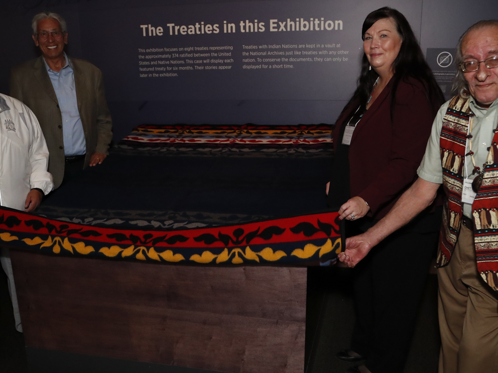 Delaware leaders prepare to unveil the Treaty of Fort Pitt, on view at the National Museum of the American Indian in Washington, D.C. From left to right: Denise Stonefish, chief of the Delaware Nation at Moraviantown; museum director Kevin Gover; Chester “Chet’ Brooks, chief of the Delaware Tribe of Indians; and Deborah Dotson, president of the Delaware Nation. May 10, 2018, Washington, D.C. (Paul Morigi/AP Images for the National Museum of the American Indian, Smithsonian)
