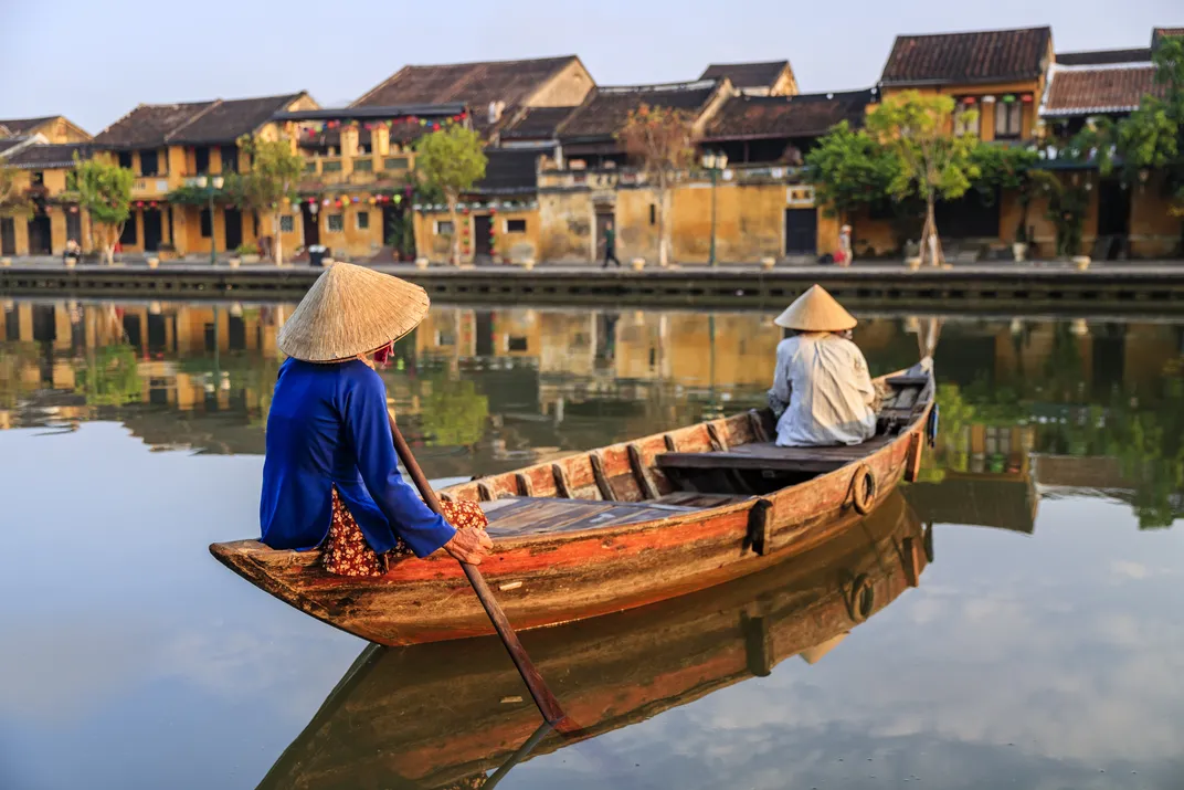 Woman in a traditional boat in Hoi An