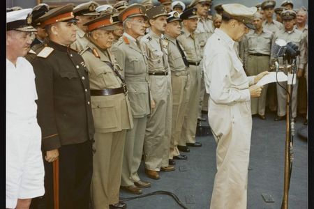 General Douglas MacArthur making remarks at the surrender ceremony aboard the USS Missouri. Behind him are representatives of the major Allied powers. U.S. National Archives, Army Signal Corps Collection, USA C-2716.