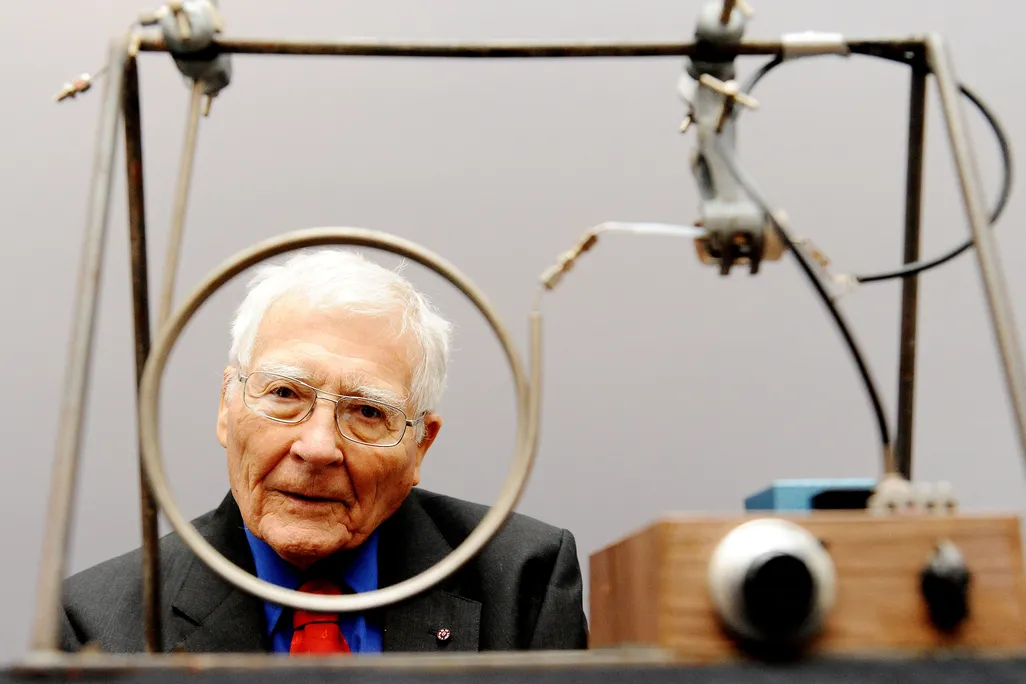 Lovelock looks through one of two wire circles on a small machine