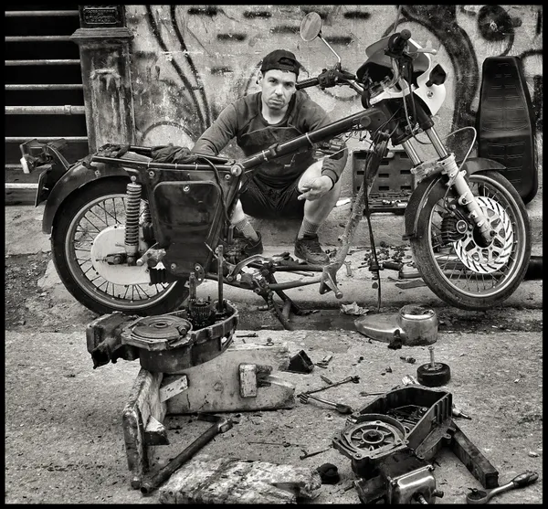 Cuban Biker Repairing his Vehicle on a Havan Street thumbnail