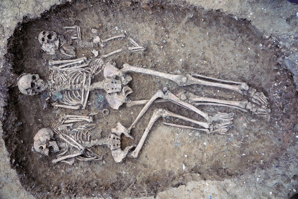 an ancient grave with two adult and one child skeleton