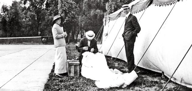 Glenn Martin (standing). By 1913 Martin was taking credit for Broadwick’s invention, and the following year he patented it. Here, he and Tiny watch Broadwick stitch up the canopy of a parachute.
