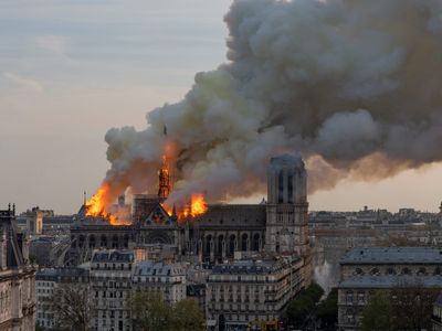 A thick cloud of smoke floats up from the Notre-Dame Cathedral as it burns, on April 15, 2019. 