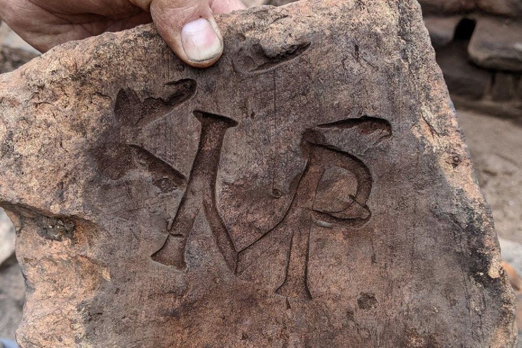 Tile stamped with the letters 'IMP'