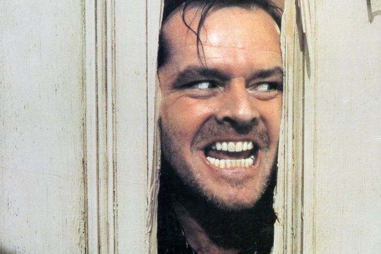 Jack Nicholson peering through an axed-in door in&nbsp;The Shining.