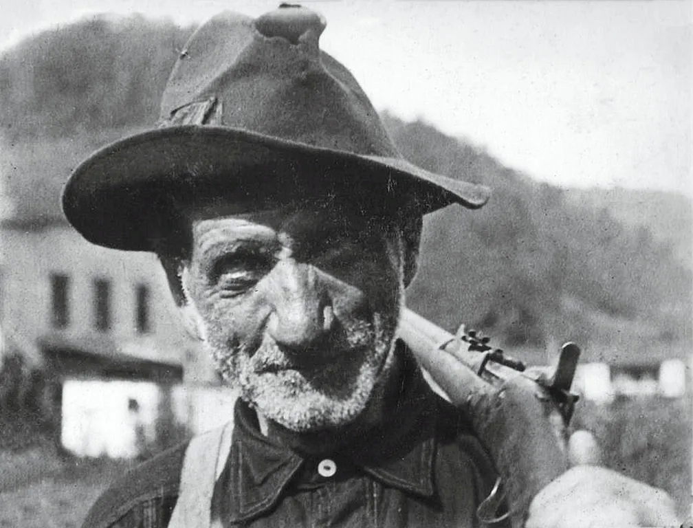 Coal miner stands with his rifle over his soldier