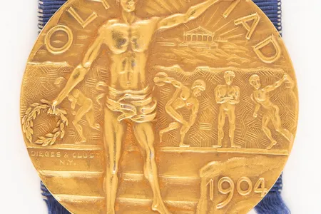 The gold medal still has its original ribbon and leather case.