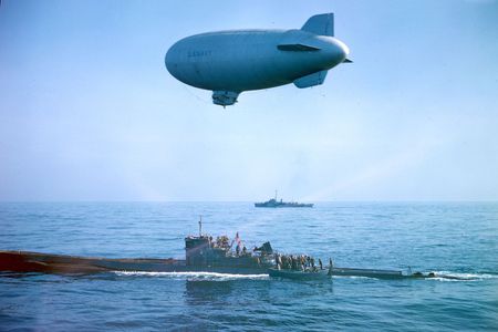 A US flag flies over the captured U-858 as it receives a K-ship escort to Lewes, Delaware. (Official US Navy photograph via National Archives and Records Administration.)