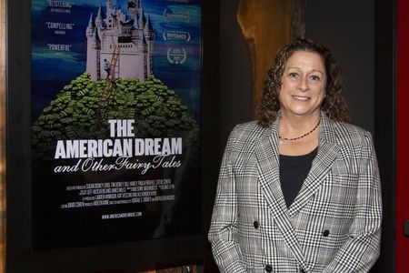 Abigail Disney beside a poster for&nbsp;The American Dream and Other Fairy Tales&nbsp;earlier this month