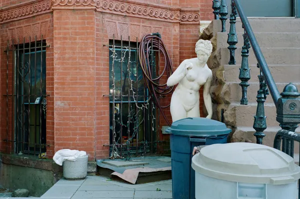 A classical statue next to trash cans in Brooklyn thumbnail