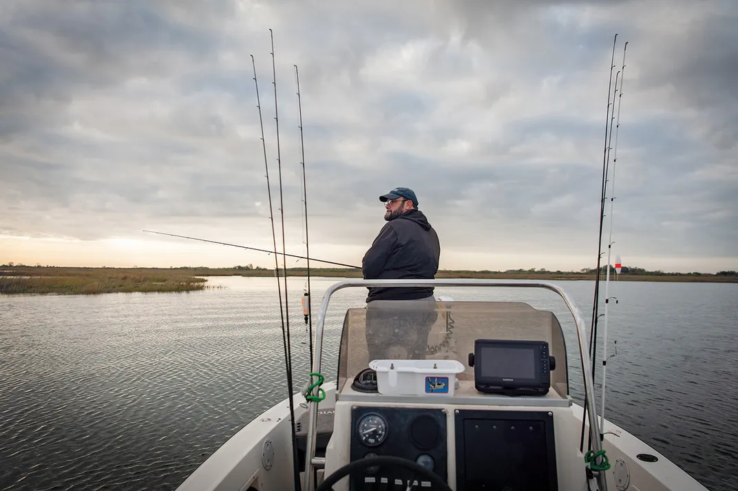 a man fishing off a boat