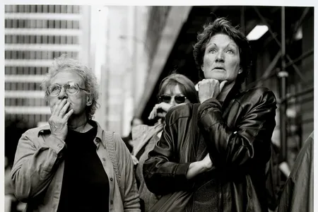 Black and white photograph of people looking at the World Trade Center.