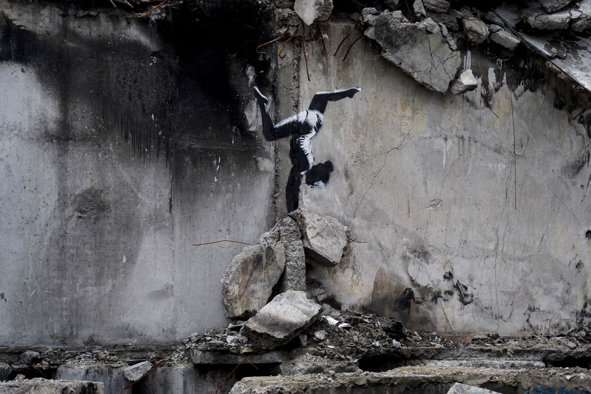 A black and white graffiti bird on a crumbling wall