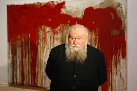 Hermann Nitsch pictured in front of one of his works at a 2006 retrospective.