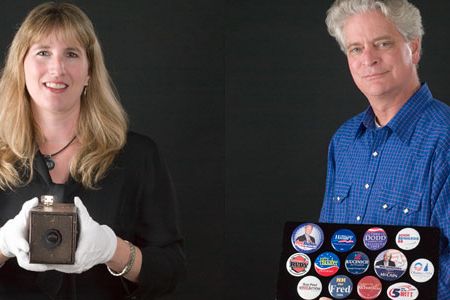 Michelle Delaney holding the original 1888 Kodak and Larry Bird holding a display of campaign buttons.