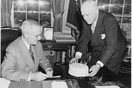 President Truman receives a birthday cake in the Oval Office in 1951. Six years earlier, his birthday coincided with V-E Day. 