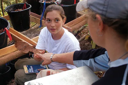 Beth Claypool, a Navy parachute rigger, holds a key find from the Laotian dig, the remains of a metal insole believed to be Bat Masterson's.