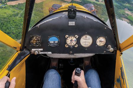 Instructor Erin Brueggen of CubAir enjoys the Wisconsin breeze in her 1946 Piper JC3 Cub in May 2021.