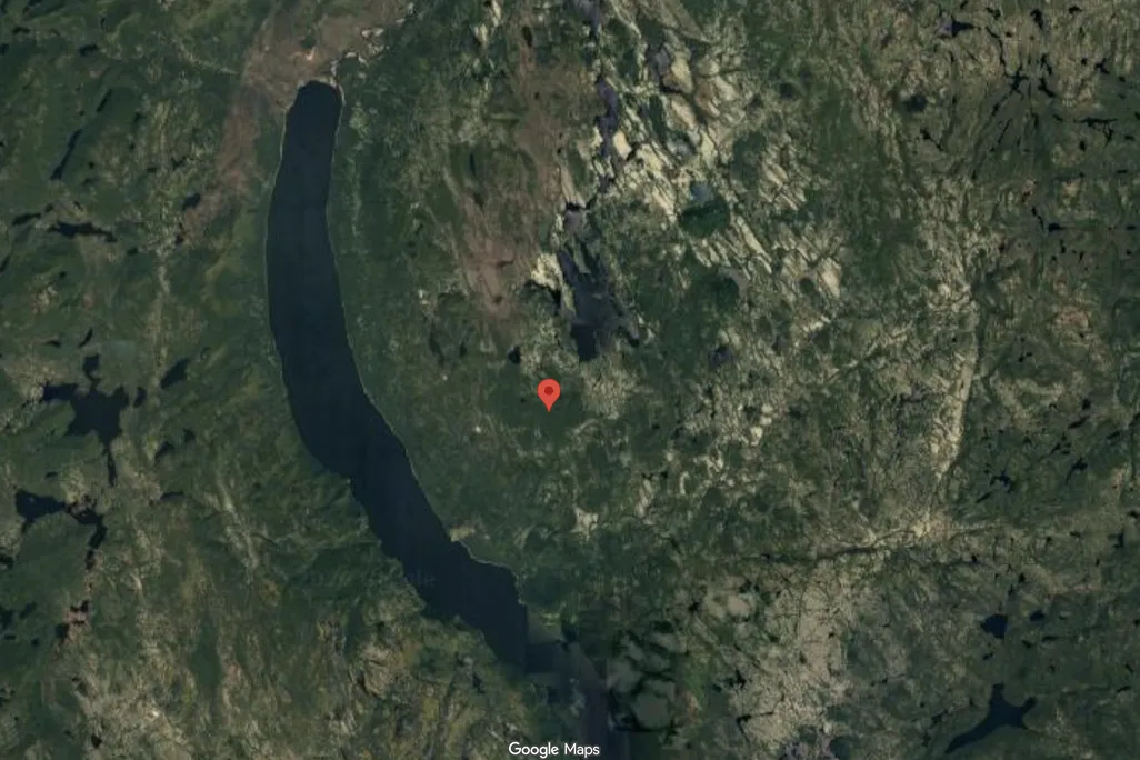 Google Maps satellite view screenshot with a red pin in the center