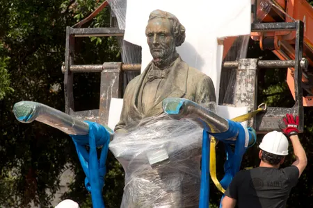A 1933 statue of Confederate leader Jefferson Davis is removed from University of Texas' South Mall after UT President Gregory Fenves cleared it to be placed in a campus museum. 