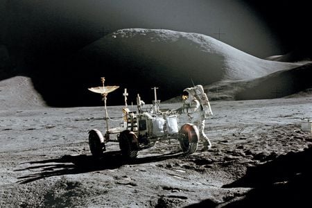 Toward the end of their first day outside, Dave Scott captured this dramatic shot of Jim Irwin and the rover, with Mt. Hadley’s summit in the background, 
12 miles away.