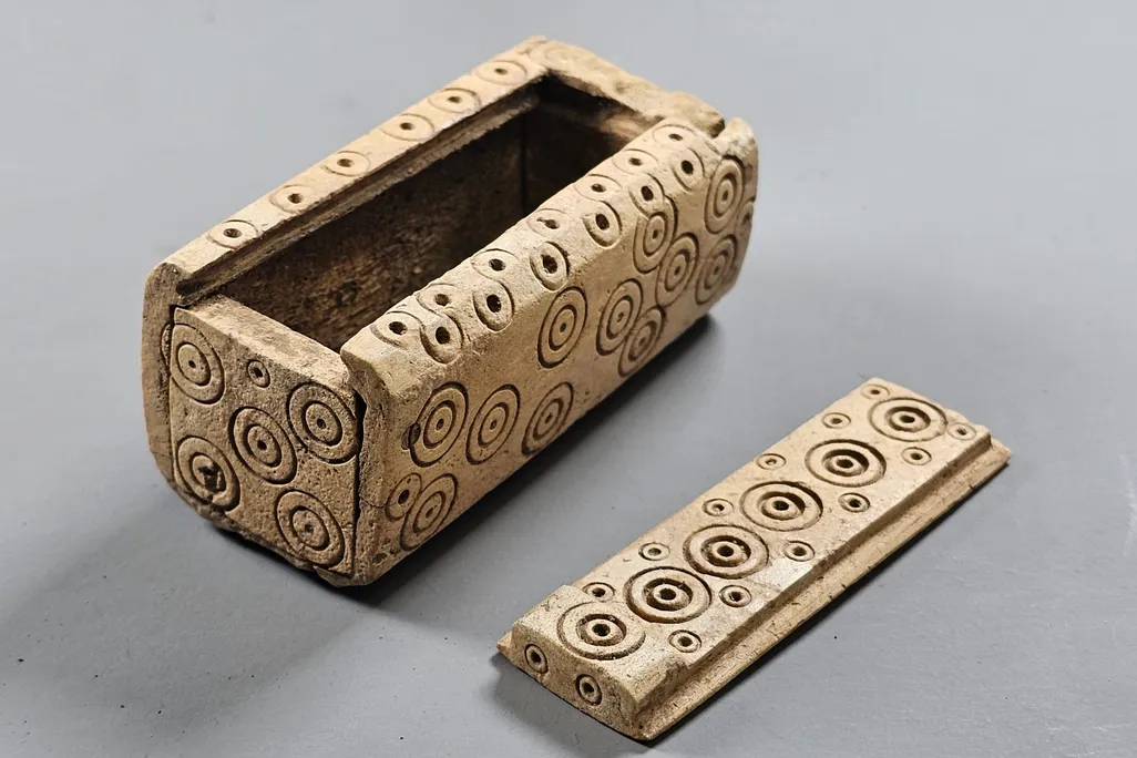 An intricately decorated white box with dots and swirls