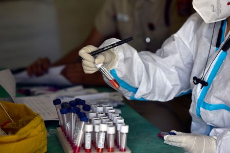 A health worker preserves mucosal swab samples at a Covid-19 testing center in New Delhi, India. 