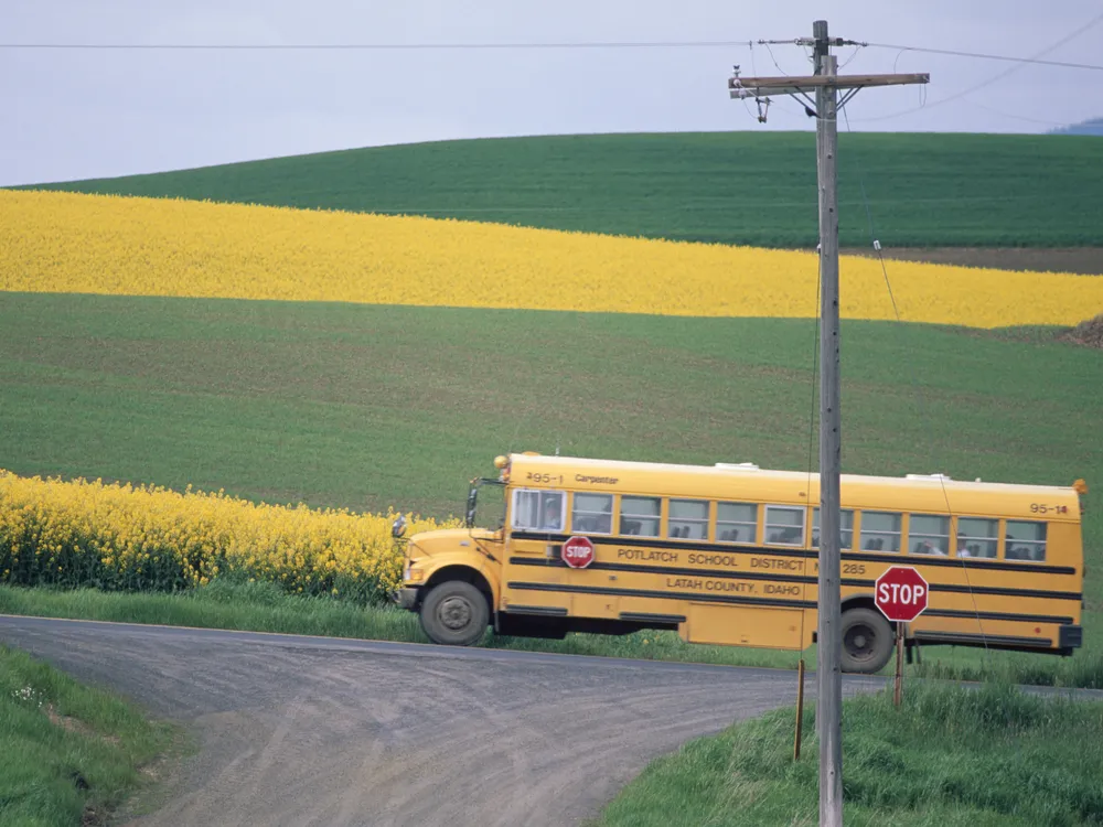 Yellow school bus beside a field