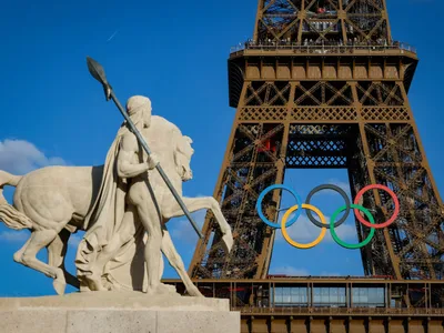 Olympic rings are seen on the Eiffel Tower near the restored statue of &quot;Cavalier Arabe&quot; on the Pont d&#39;I&eacute;na bridge in Paris on July 4, 2024, ahead of the upcoming Paris 2024 Olympic Games.&nbsp;