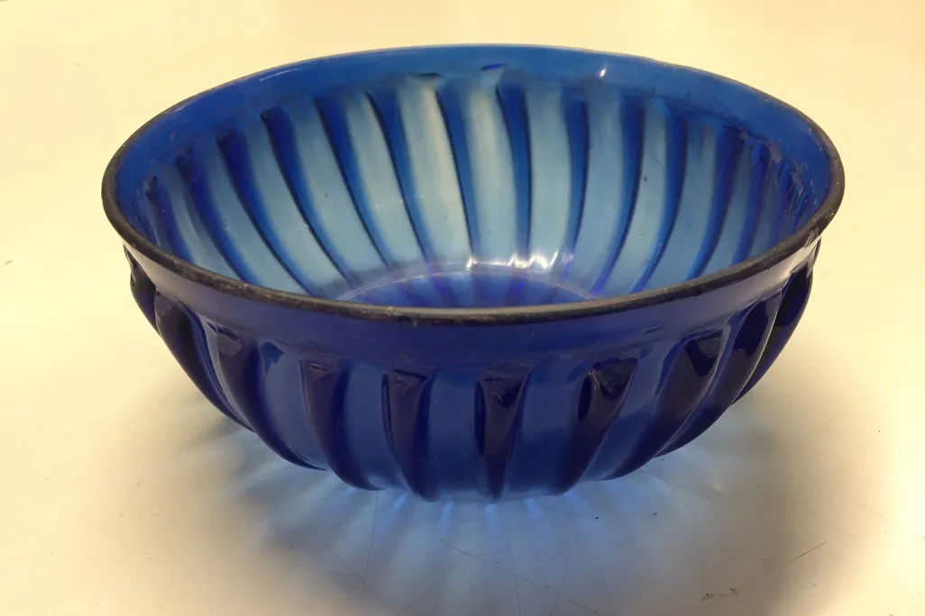 A close up shot of the blue glass bowl on a table