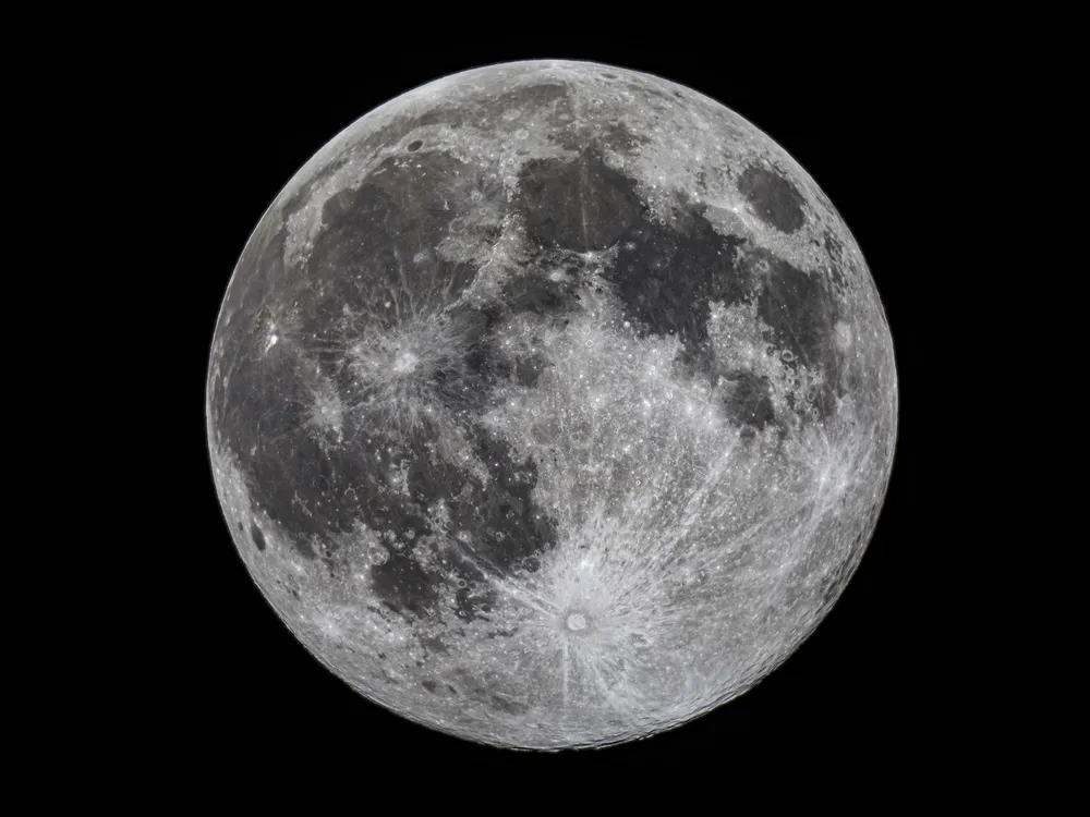the full moon against a black background